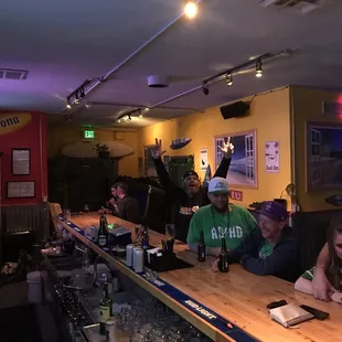 a group of people sitting at a bar