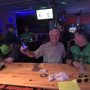 a group of men sitting at a bar