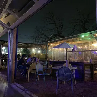 people sitting at tables outside at night