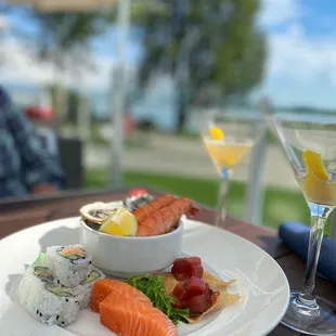 a plate of sushi and a martini