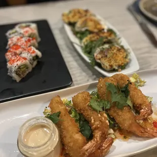 Coconut shrimp, bakes oysters, and salmon skin sushi rolls