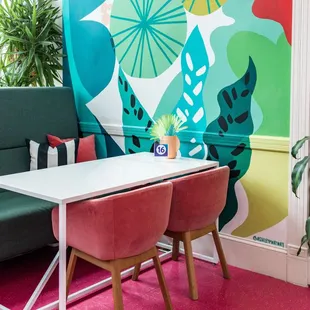 Bright, vibrant workspace with local artists featured throughout.