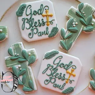 four decorated cookies on a plate