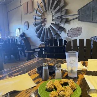 a green plate of food on a wooden table