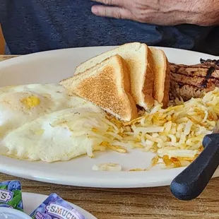 Over medium eggs, hash browns, toast and a side of pork chop
