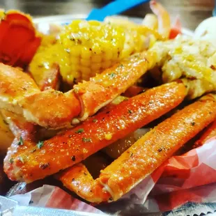 crab legs, corn and potatoes