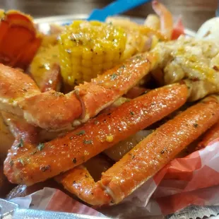 crab legs, corn and potatoes