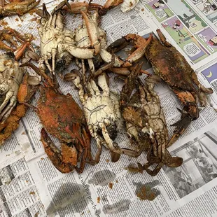 a pile of crabs on a newspaper