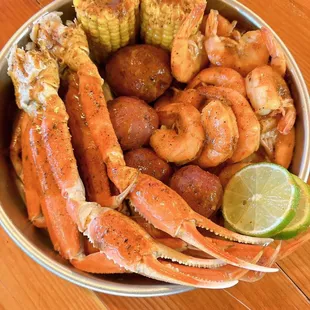 crab legs, corn, potatoes, and corn on the cob