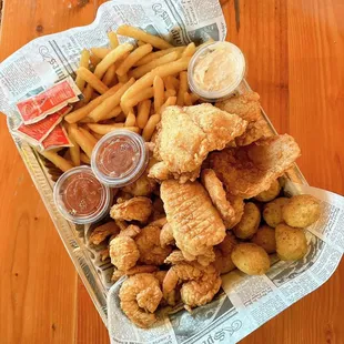 a basket of fried fish and fries