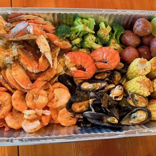 a tray of seafood and vegetables
