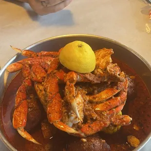 a plate of crab legs with a lemon on top