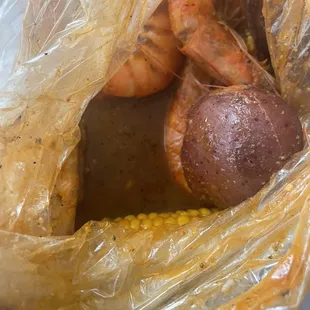 Shrimp potatoes and the bottom of the bag that shows soupy Shazam sauce