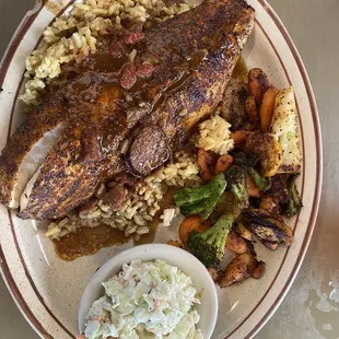Redfish topped with gumbo over rice with grilled veggies and coleslaw.