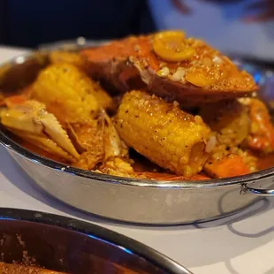 a bowl of crab and corn on the cob