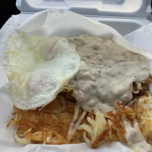 Chicken fried steak and eggs over medium.