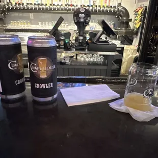 two cans of beer on a bar
