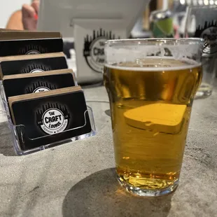 a glass of beer and a credit card