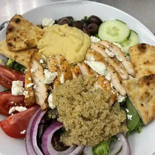 Mediterranean Chicken salad made fresh with seasoned grilled Chicken, quinoa, hummus, feta cheese, tomatoes, onion, cucumbers, and olives.