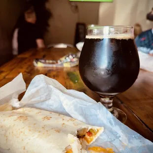 a burrito and a glass of beer