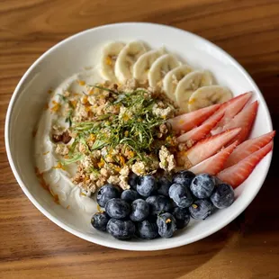 a bowl of oatmeal with fruit and nuts