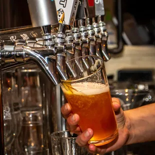 a person pouring a beer