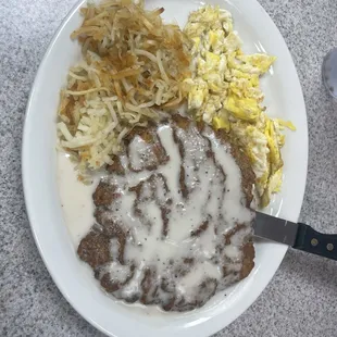 Chicken fried steak with eggs and hashbrowns