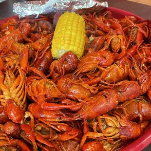 a plate of crawfish and corn