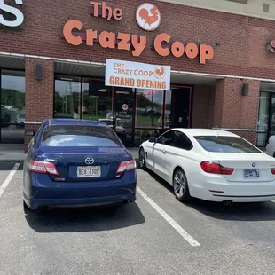two cars parked in front of the store