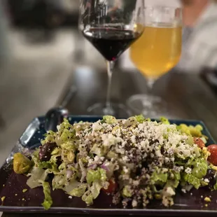 Mediterranean quinoa salad with cucumbers, grape tomatoes, red onion, kalamata olives, pistachios, feta, pepperoni with a lemon vinaigrette