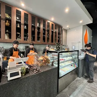 a group of people working in a bakery