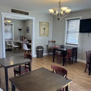 a dining room and kitchen with a television on the wall