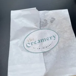 a pastry in a paper bag