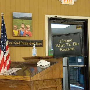 a wooden counter with a sign on it