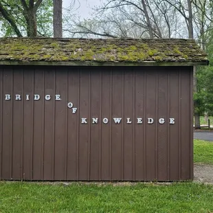 a small building with moss growing on the roof