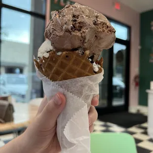Chocolate Amaretto Cheesecake and Cookie Monster ice cream in a waffle cone