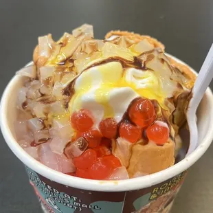 Frozen Thai Tea rolled ice cream with bubble and lychee jelly, with mango and chocolate syrups