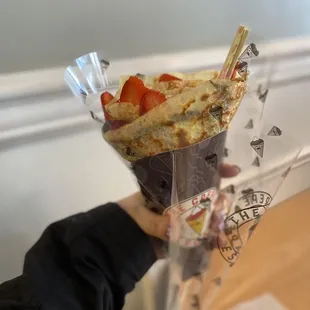 a person holding a piece of cake