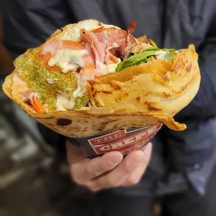 a person holding a sandwich