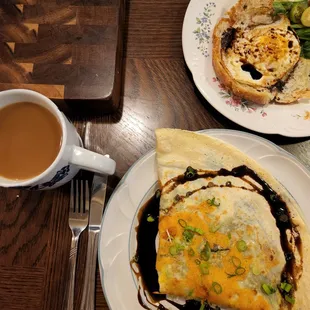 a plate of food and a cup of coffee