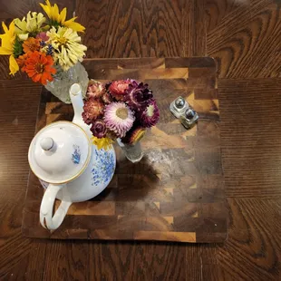 a teapot with flowers in it