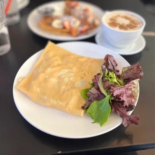 a plate of food and a cup of coffee