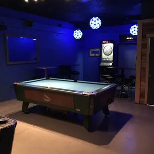 2 pool tables and a dart board.