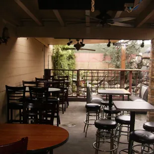 a patio with tables and stools