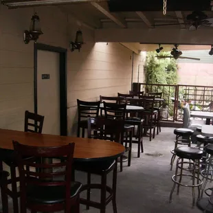 a patio with tables and chairs