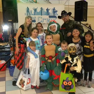 Taking a group photo with kids in costume at one of our Halloween Events.