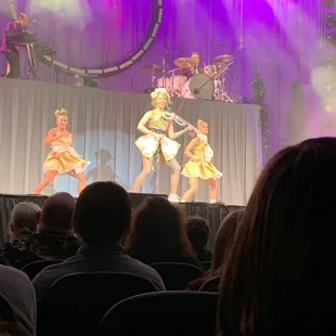 a group of dancers performing on stage