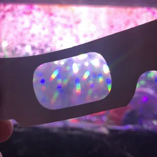 a hand holding a pair of 3d glasses