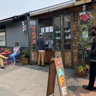 people sitting outside of the cafe