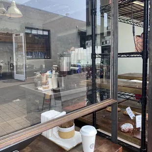a view of a coffee shop through the window
